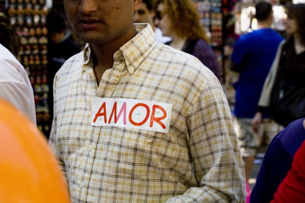 Pakistanian man walking by "Las Ramblas" with a love sticker on her shirt. Today is the day of the love in Barcelona.